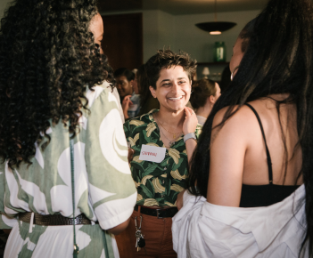 Photo of a Creative Access alumni smiling in conversation at a Creative Access event.