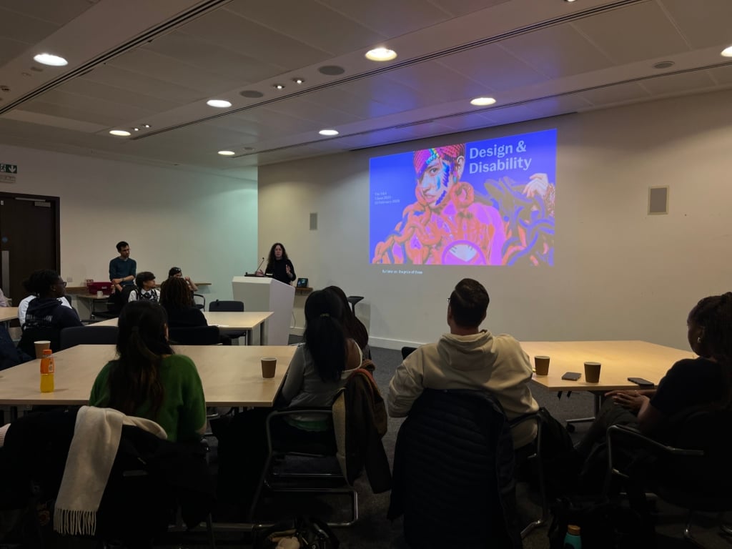 A class of students with a speaker presenting at the V&A
